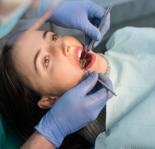 A woman being treated by a dentist