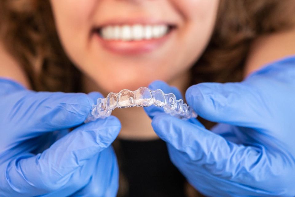 Person smiling while getting a retainer