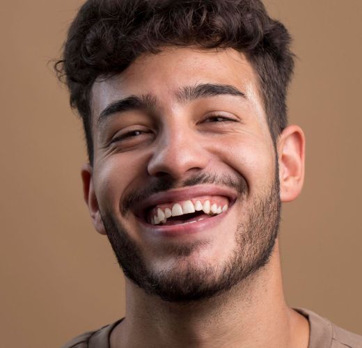 A man smiling with a white smile