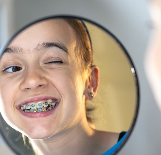 Caucasian preteen with braces smiling